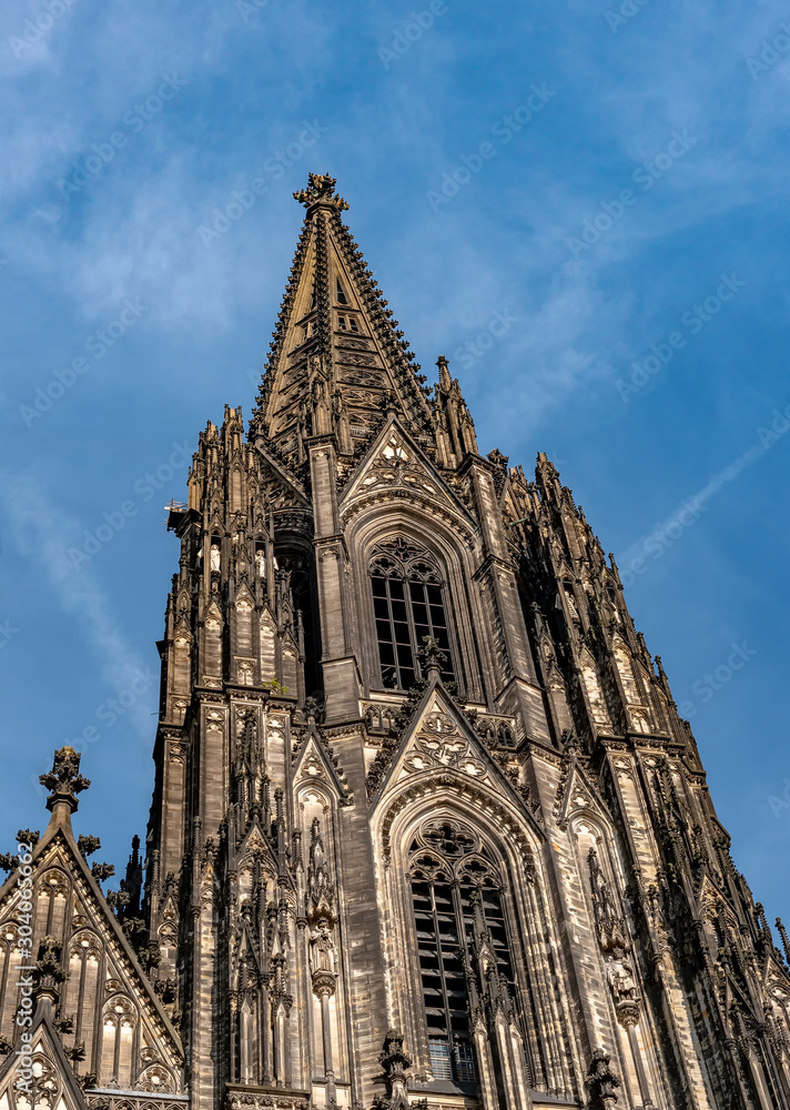 Gothic Cathedral Church of Saint Peter in Cologne, Germany on a sunny day. Beautiful cityscape with details of the towers, arches and windows stained glass