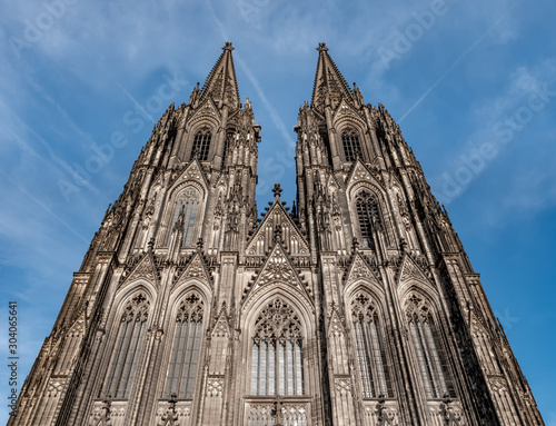 Gothic Cathedral Church of Saint Peter in Cologne, Germany on a sunny day. Beautiful cityscape with details of the towers, arches and windows stained glass