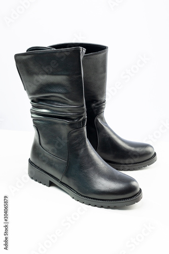 women's black demi-season leather boots on white background