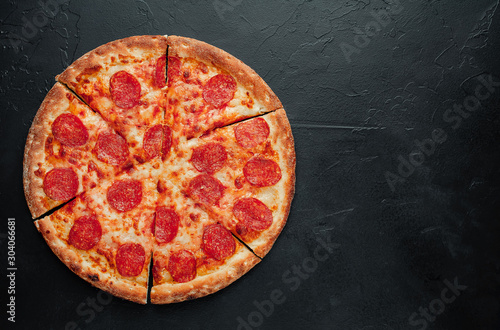 Pepperoni pizza on stone background with copy space for your text, ready to eat.