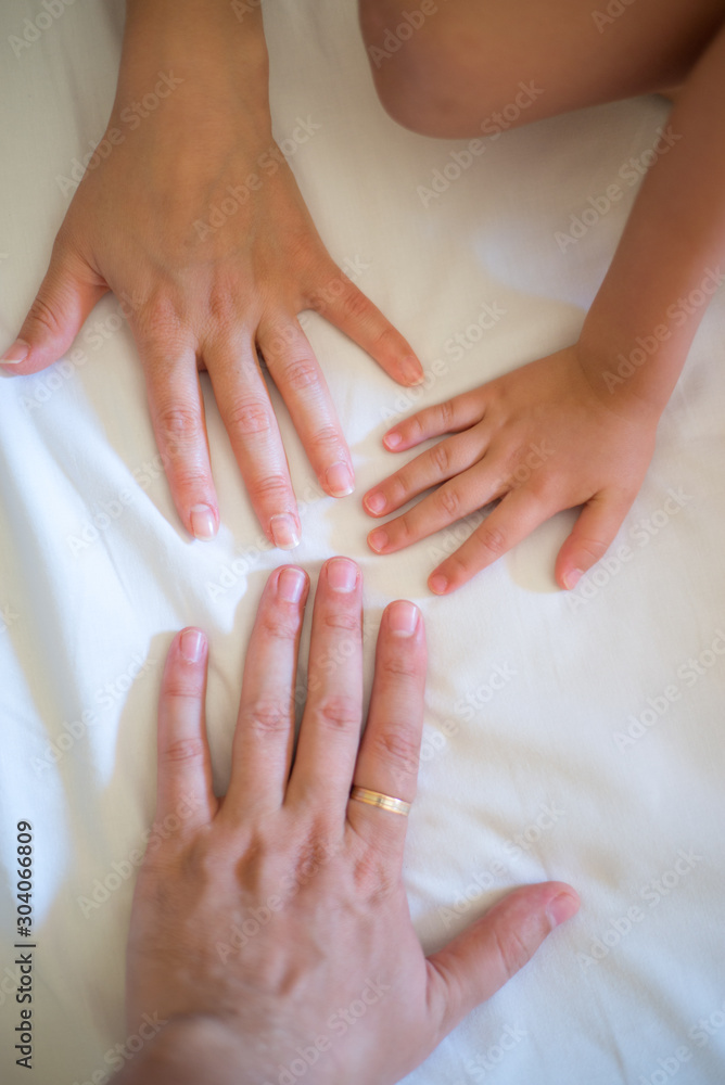 Naklejka premium Hands of Mother, father and little daughter. Concept of unity, support, protection and happiness. Family hands