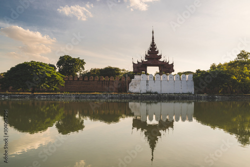 Palace wall with trees reflecting in the water - Mandalay Palace, Myanmar