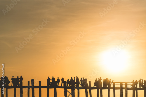 Silhouettes of people on the U-Bein Bridge near Mandalay at sunset