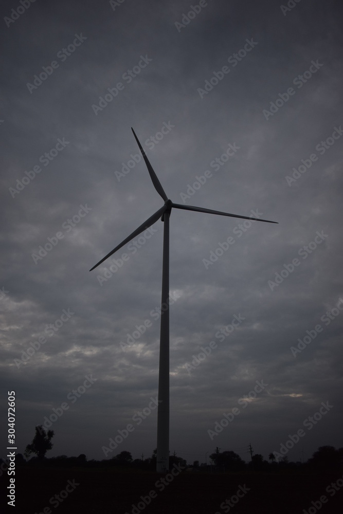 The windmil under the sky in the field