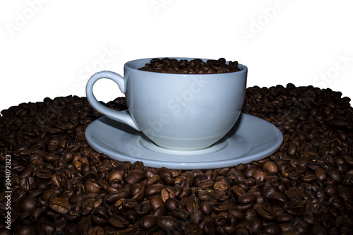 A cup of coffee beans standing in the middle of coffee beans on a white background