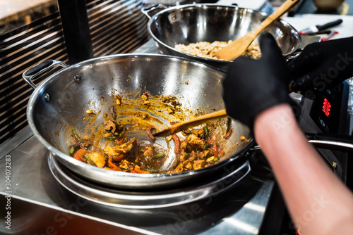 chef cooking noodles in the restaurant photo