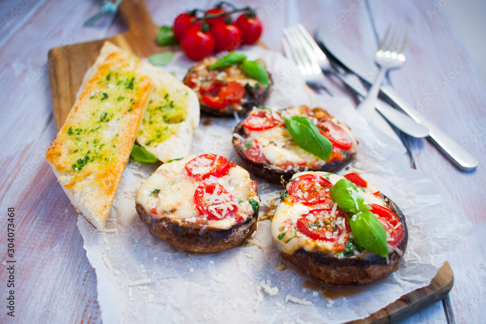 Grilled champignon portobello stuffed with mozzarella, cherry tomatoes and basil with garlic herb baguette