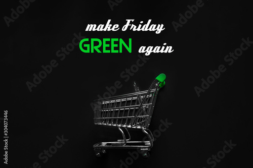 Make Friday Green again text on black background with empty shopping cart - concept