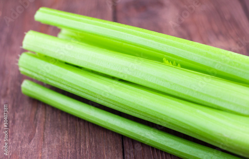 fresh organic celery on wooden background, close-up