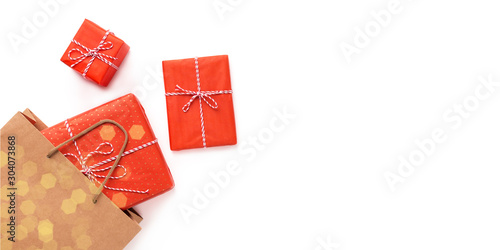 Christmas gifts creatively popping out of shopping bag