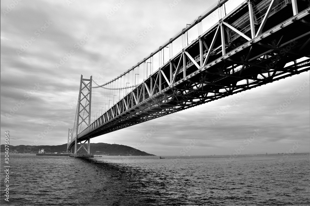 Japanese bridge to island in black and white