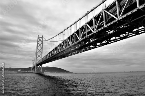 Japanese bridge to island in black and white