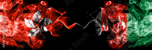 Hong Kong, China vs Afghanistan, Afghani smoky mystic states flags placed side by side. Concept and idea thick colored silky abstract smoke flags photo