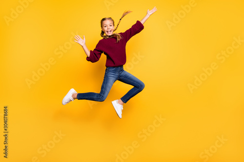 Full length body size view of her she nice attractive careless cheerful cheery playful pre-teen girl having fun jumping weekend free time isolated on bright vivid shine vibrant yellow color background