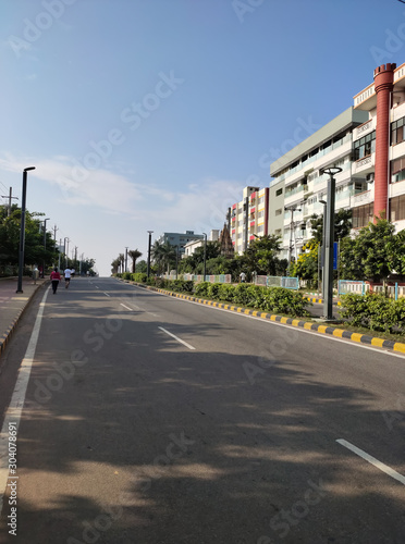 City road along with building and green trees.