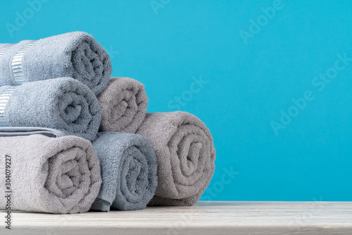 Stack of rolled towels on a wooden table