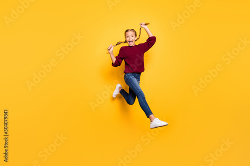Turned full length body size photo of cheerful positive ecstatic overjoyed girl in jeans denim footwear burgundy sweater expressing astonishment isolated vivid color background