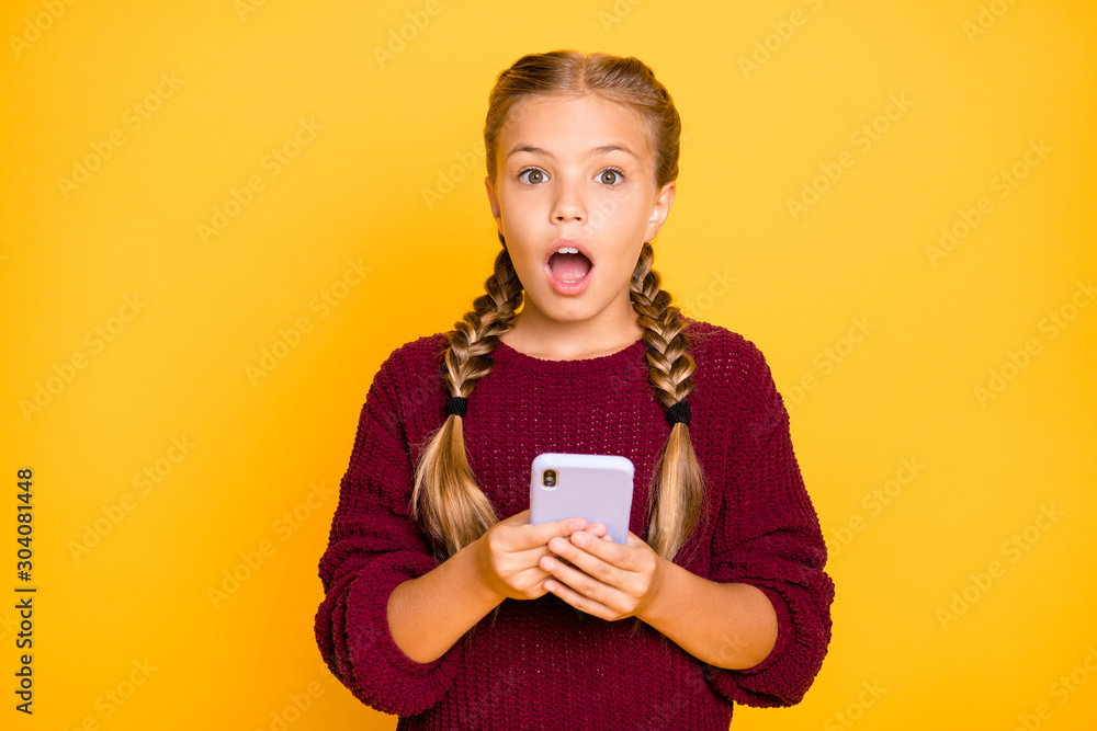 Close-up portrait of her she nice attractive lovely wondered astonished stunned pre-teen girl using cell media reaction feednews isolated on bright vivid shine vibrant yellow color background Close-up portrait of her she nice attractive lovely wondered astonished stunned pre-teen girl using cell media reaction feednews isolated on bright vivid shine vibrant yellow color background
