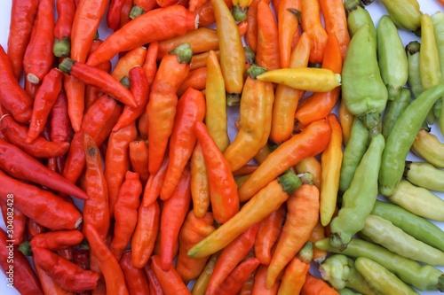 Three color red peppers, highlighting the selection of pepper, colorful organic food ingredients, use as background