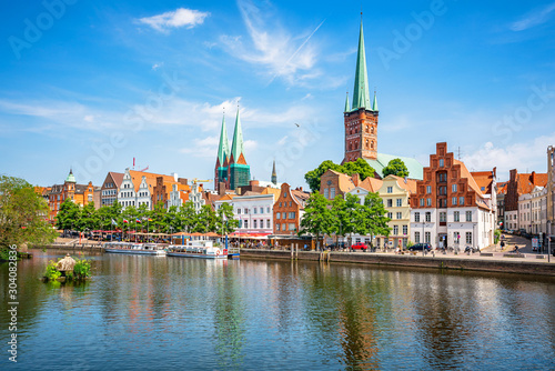 Classic panoramic view of historic skyline of hanseatic town of Lübeck with famous St. Mary's Church on a beautiful sunny day with blue sky in summer, Schleswig-Holstein, Germany photo