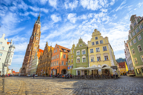 Scenic panoramic view of historic town of Landshut with traditional colorful houses and famous St. Martin's Church on a beautiful sunny day with blue sky and clouds in summer, Bavaria, Germany
