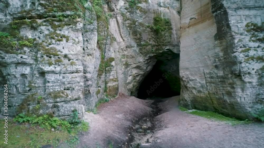 Devil's Oven or Large Ellite Natural Geological Monument Located in the Gauja National Park at Lode Behind Cesis in Latvia. Licu Langu Sandstone Cliffs Liepa Cave. Aerial Dron Shoot. Devil's Oven or Large Ellite Natural Geological Monument Located in the Gauja National Park at Lode Behind Cesis in Latvia. Licu Langu Sandstone Cliffs Liepa Cave. Aerial Dron Shoot.