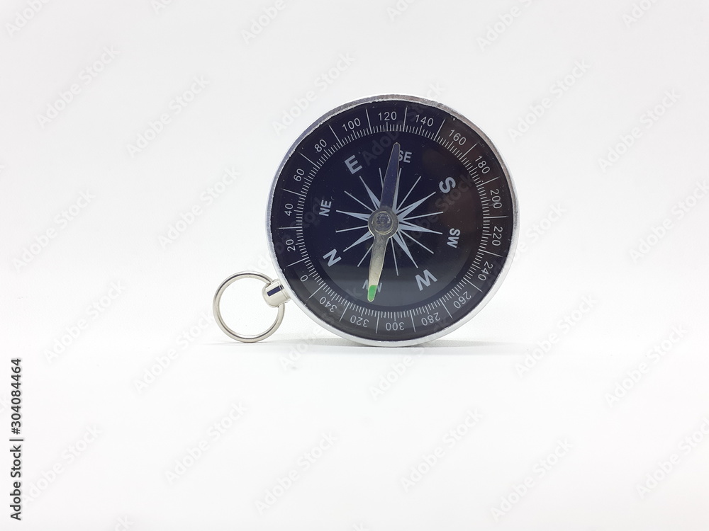 Useful Metallic Dark Needle Magnetic Hand Compass to Show Direction when Camping or Travelling Concept in White Isolated Background Useful Metallic Dark Needle Magnetic Hand Compass to Show Direction when Camping or Travelling Concept in White Isolated Background