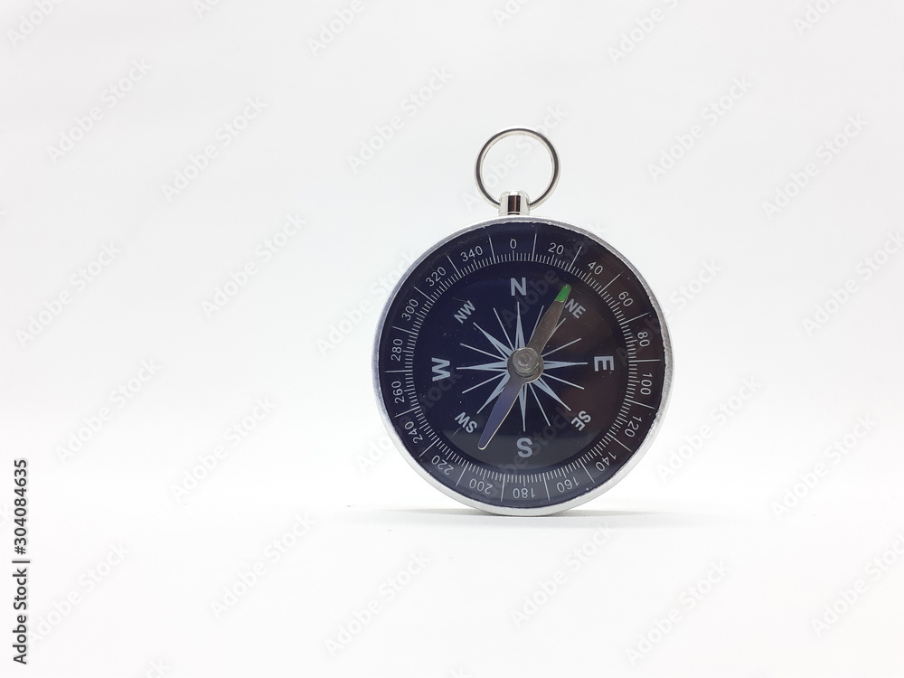Useful Metallic Dark Needle Magnetic Hand Compass to Show Direction when Camping or Travelling Concept in White Isolated Background Useful Metallic Dark Needle Magnetic Hand Compass to Show Direction when Camping or Travelling Concept in White Isolated Background
