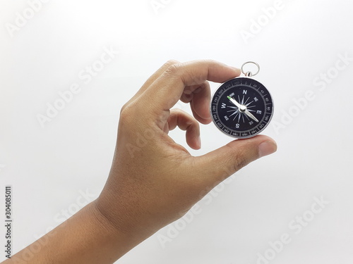 Useful Metallic Dark Needle Magnetic Hand Compass to Show Direction when Camping or Travelling Concept in White Isolated Background