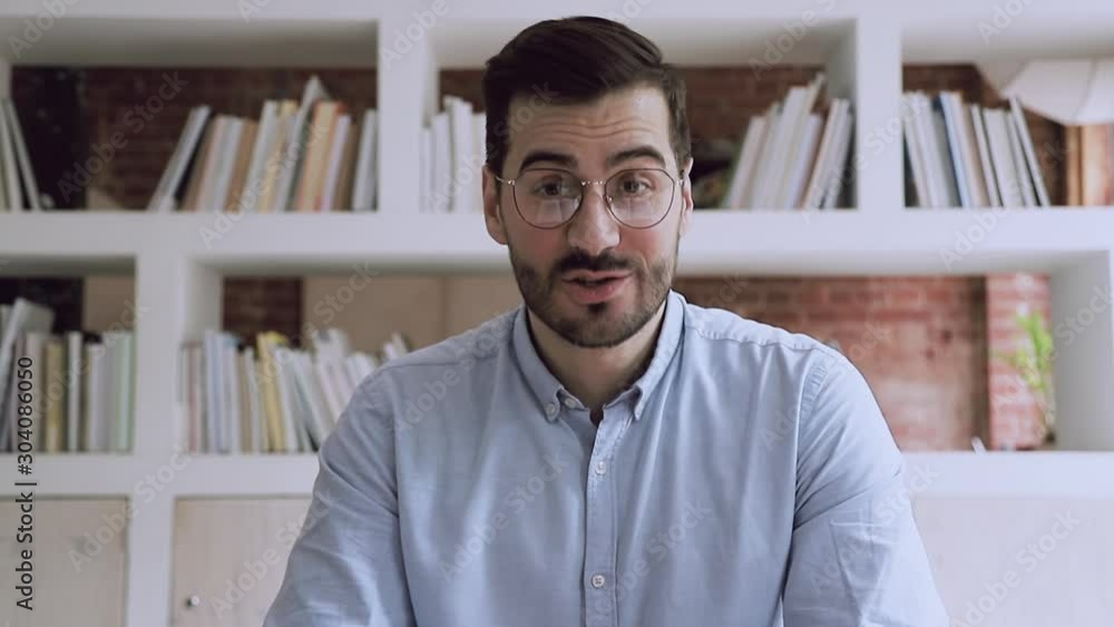 Confident businessman webinar speaker coach teacher talking looking at camera