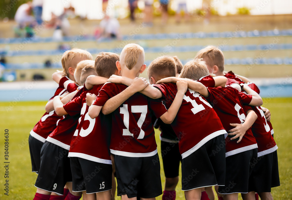 Children Playing Sports. Happy Kids Sports Team. Youth Sports Players Gathering in Team. Parents Spectators in the Blurred Background Children Playing Sports. Happy Kids Sports Team. Youth Sports Players Gathering in Team. Parents Spectators in the Blurred Background