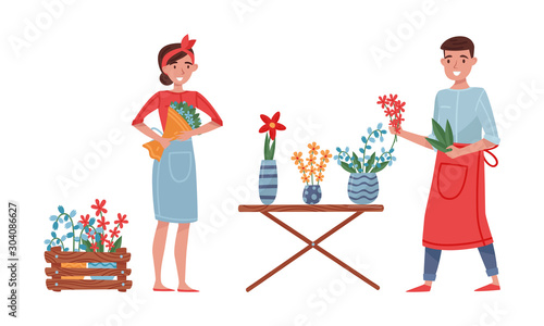 Floristry Concept. Flower Arrangers Taking Care of Plants and Flowers