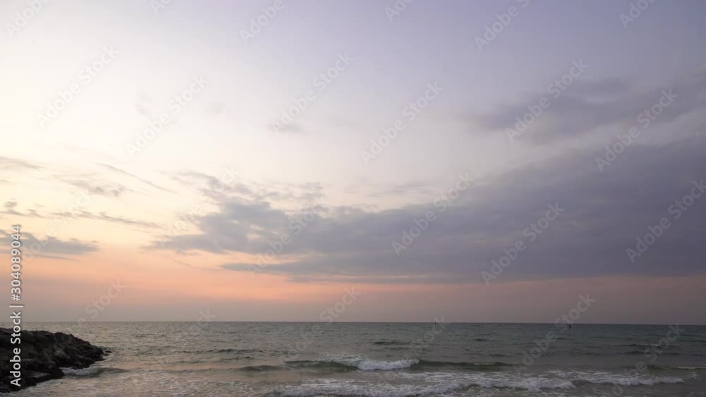 Wide angle seascape view looking straight into the sunset horizon, ocean at the sunset time and cloudy sky, Gorgeous panoramic view of a colorful orange and purple sunrise over Arabian or Persian gulf Wide angle seascape view looking straight into the sunset horizon, ocean at the sunset time and cloudy sky, Gorgeous panoramic view of a colorful orange and purple sunrise over Arabian or Persian gulf