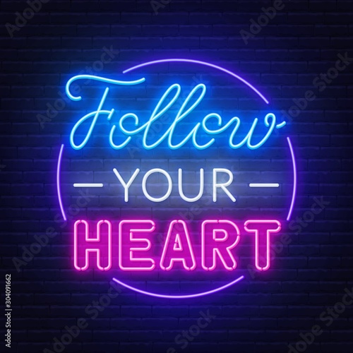 Follow your heart neon lettering on dark background