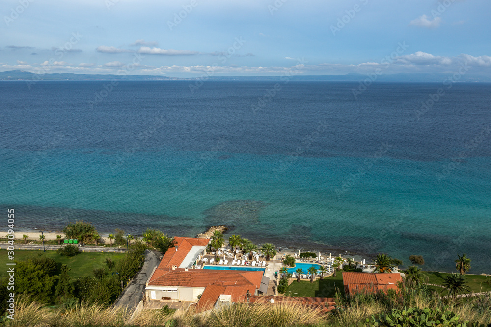 Beautiful sea landscape. View from above at small cozy hotel resort at scenic beach. Horizontal color photography.