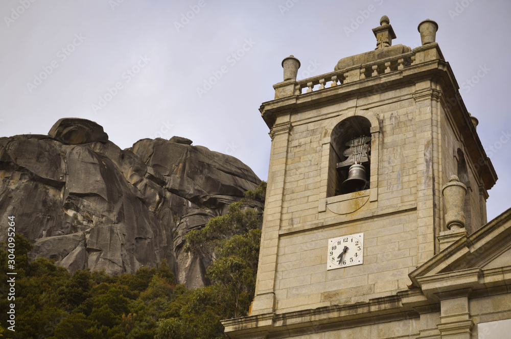 Obraz premium The bell tower in the mountains, in the background Rocky Mountain. Geres. Portugal. Europe