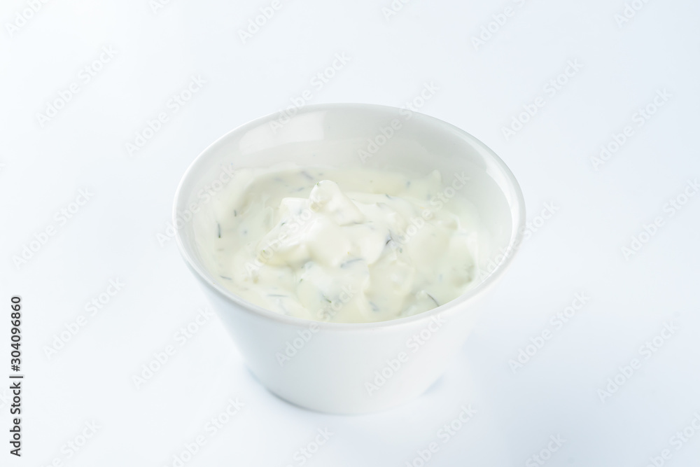 cream sauce with pickles in a bowl on a light background, mayonnaise cream sauce with pickles in a bowl on a light background, mayonnaise