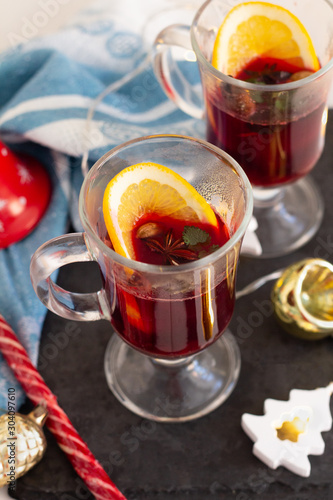 mulled wine of red wine and spices and orange and Christmas decorations