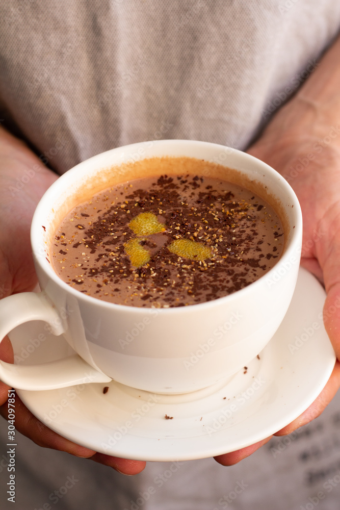 a cup of hot chocolate with chocolate chips and orange zest a cup of hot chocolate with chocolate chips and orange zest