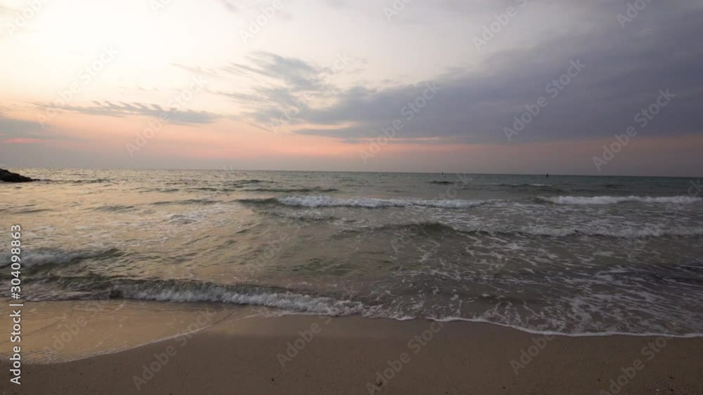 Wide angle seascape view looking straight into the sunset horizon, ocean at the sunset time and cloudy sky, Gorgeous panoramic view of a colorful orange and purple sunrise over Arabian or Persian gulf Wide angle seascape view looking straight into the sunset horizon, ocean at the sunset time and cloudy sky, Gorgeous panoramic view of a colorful orange and purple sunrise over Arabian or Persian gulf
