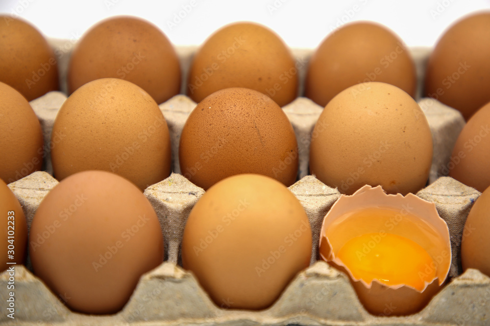 Brown chicken egg in paper box isolated on white background Brown chicken egg in paper box isolated on white background