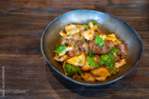 Stir Fried Rice Noodle with Chicken on wooden table