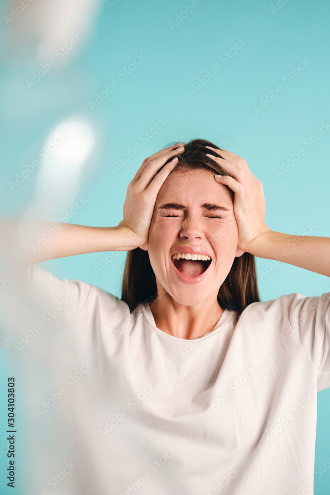 Unhappy girl closing eyes scaredly screaming on plastic over colorful background isolated Unhappy girl closing eyes scaredly screaming on plastic over colorful background isolated
