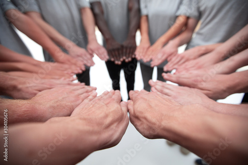 group of young people standing with open palms