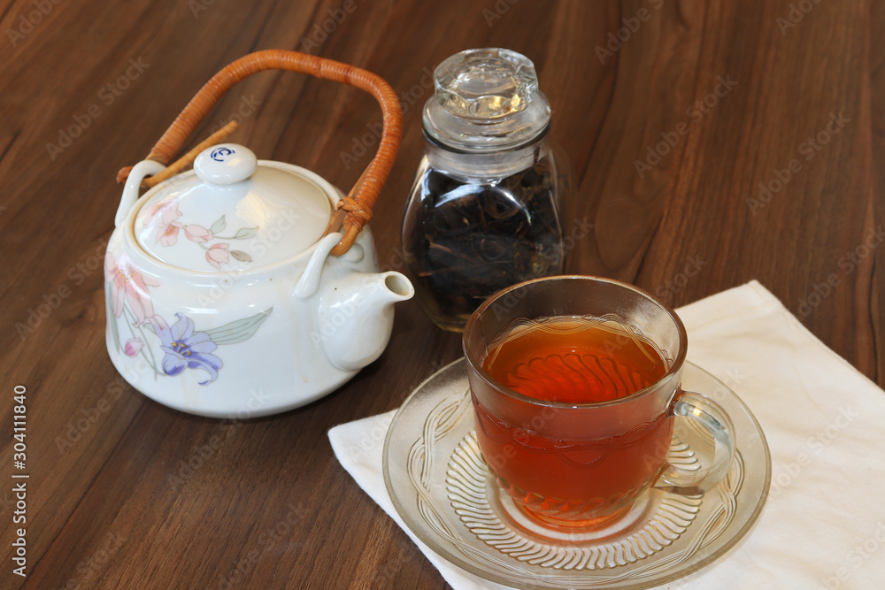 Green tea cups and glass jars with dry green tea Green tea cups and glass jars with dry green tea