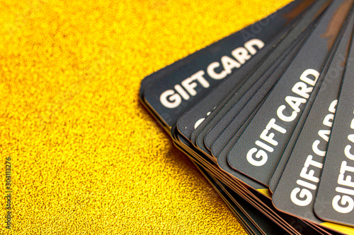 gift card stack on glitter gold background space 