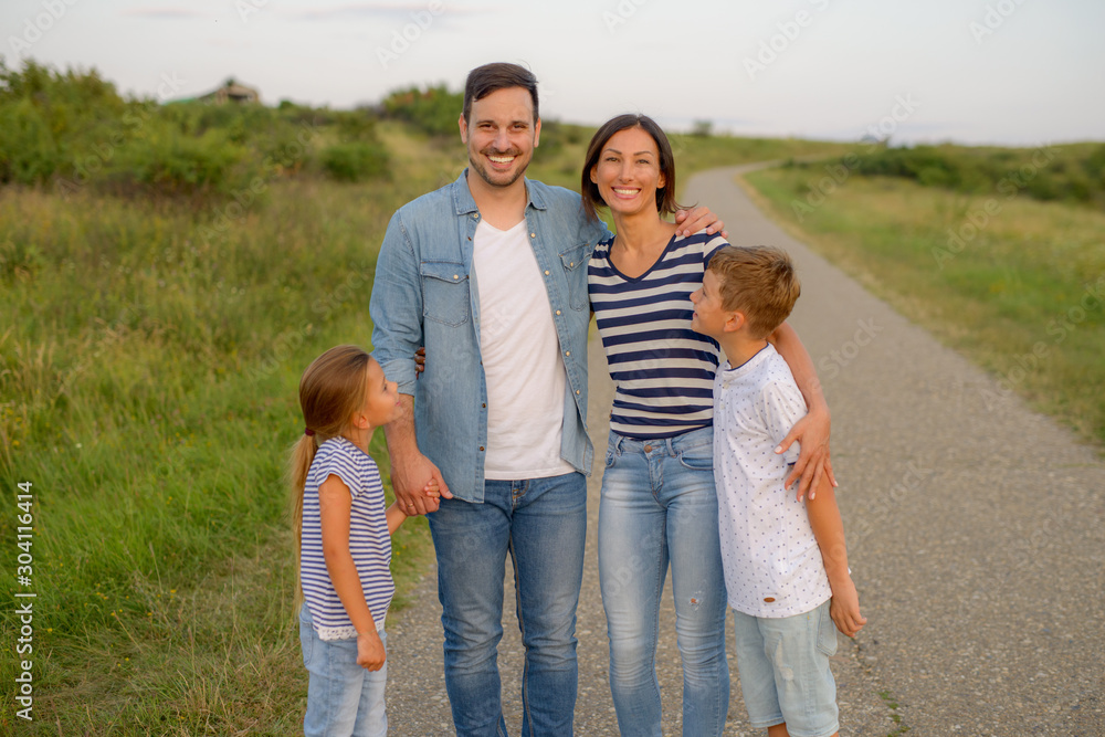 Shot of a family of four enjoying a sunny day in the nature Shot of a family of four enjoying a sunny day in the nature
