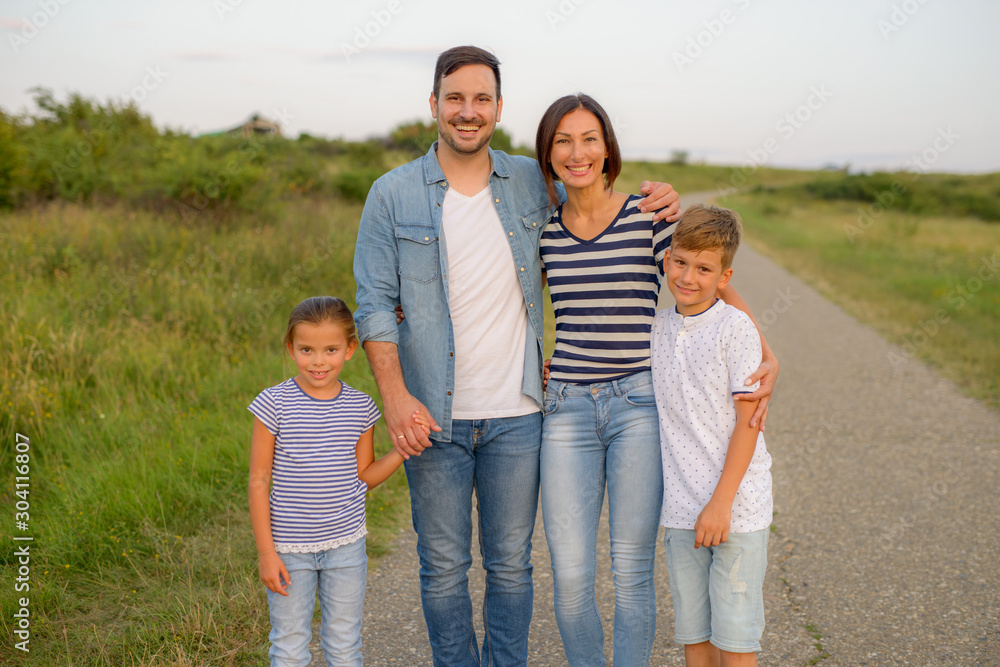 Shot of a family of four enjoying a sunny day in the nature Shot of a family of four enjoying a sunny day in the nature