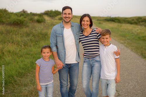 Shot of a family of four enjoying a sunny day in the nature