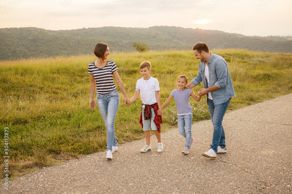 Shot of a family of four enjoying a sunny day in the nature Shot of a family of four enjoying a sunny day in the nature